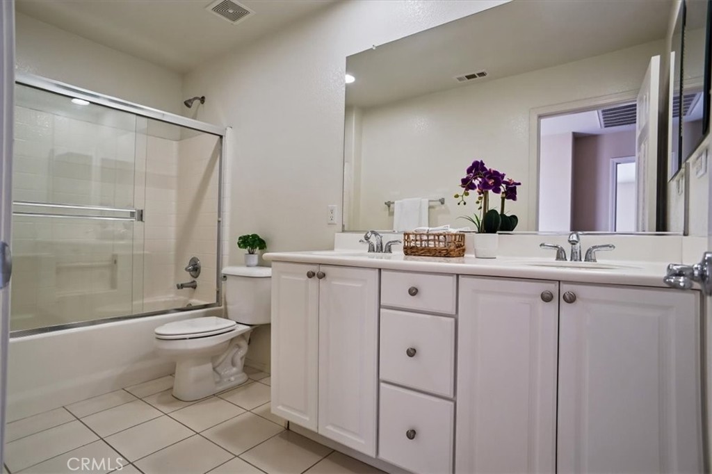 20046 Christopher Lane Saugus, CA 91350 - Photo 21 of 25 a bathroom with a double vanity sink mirror and toilet