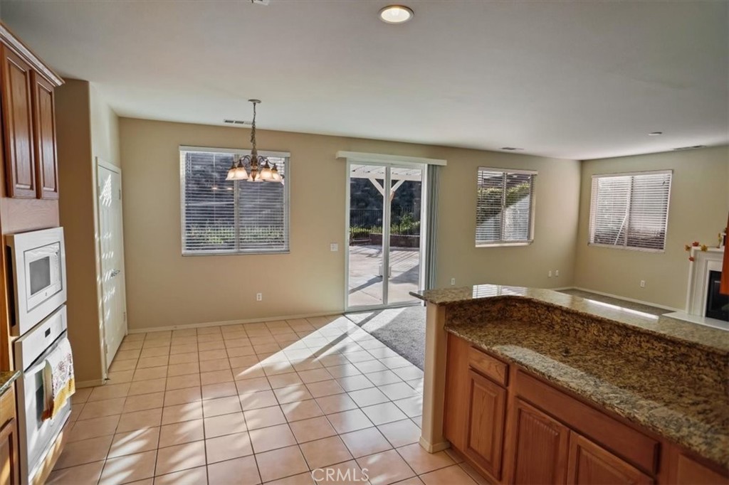 20046 Christopher Lane Saugus, CA 91350 - Photo 7 of 25 a view of hallway with granite countertop cabinets and chandelier