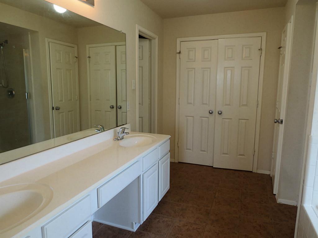 22303 Bridgestone Ridge Drive Spring, TX 77389 - Photo 14 of 25 a bathroom with a sink and a mirror