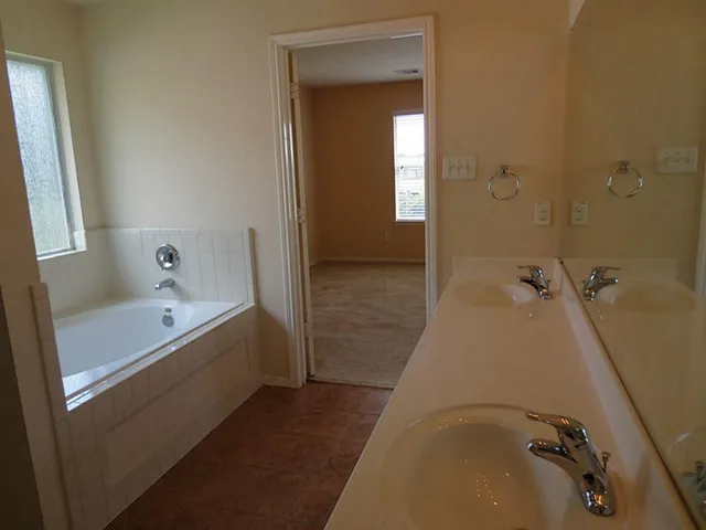 a bathroom with a tub and shower