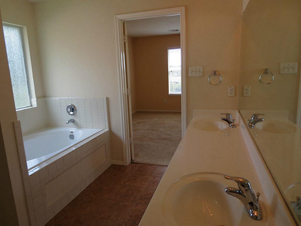 22303 Bridgestone Ridge Drive Spring, TX 77389 - Photo 15 of 25 a bathroom with a tub and shower