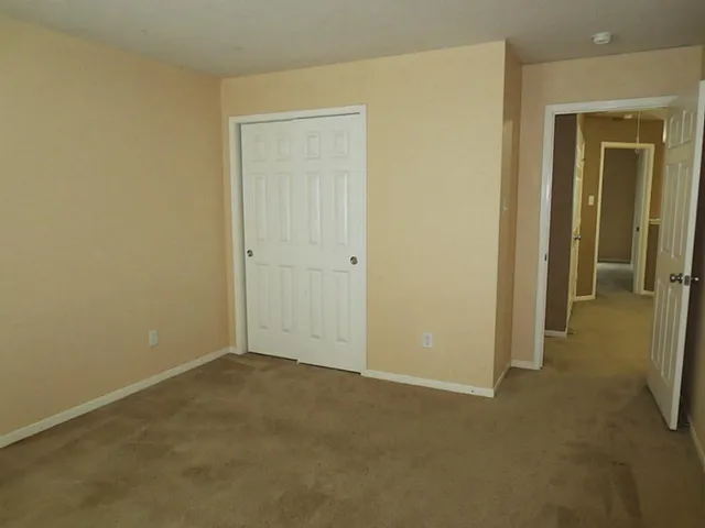 an empty room with closet area