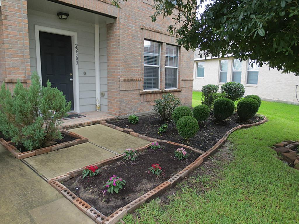 22303 Bridgestone Ridge Drive Spring, TX 77389 - Photo 2 of 25 a view of a backyard with potted plants