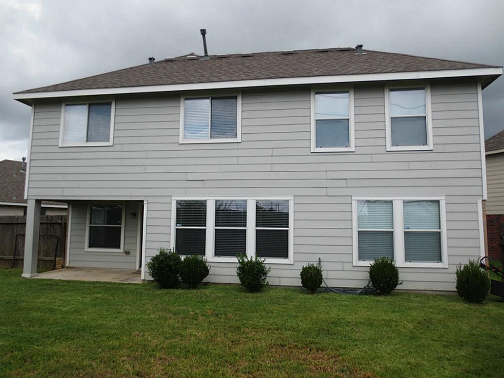 22303 Bridgestone Ridge Drive Spring, TX 77389 - Photo 23 of 25 a brick house with a yard