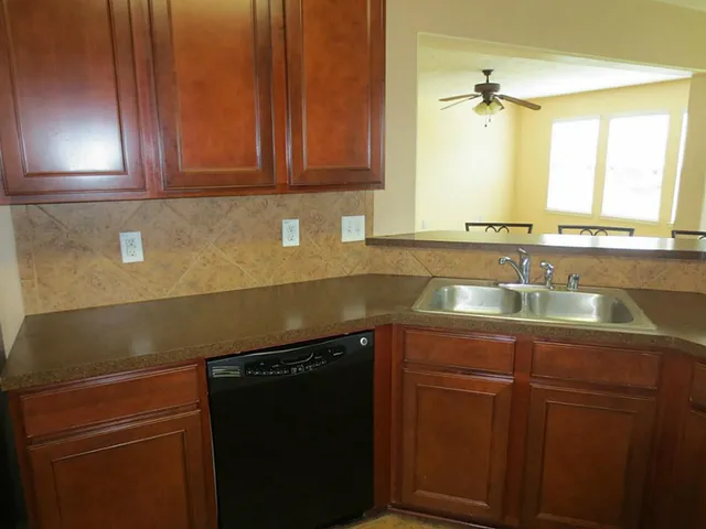 a kitchen with sink and cabinets