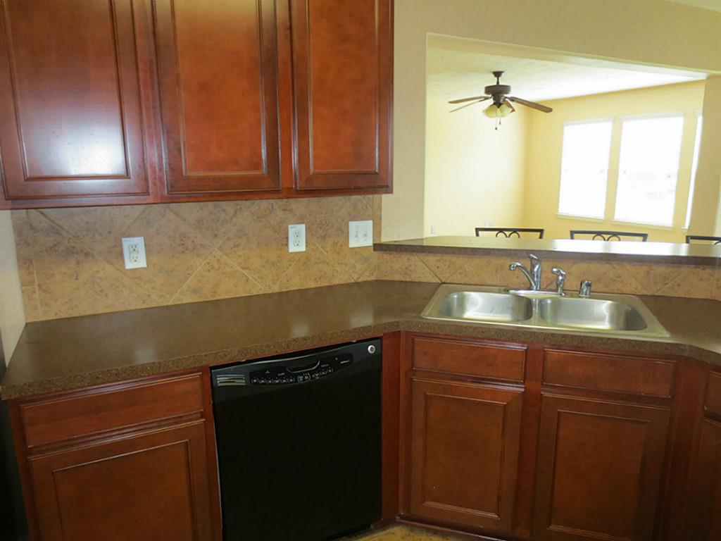 22303 Bridgestone Ridge Drive Spring, TX 77389 - Photo 7 of 25 a kitchen with sink and cabinets