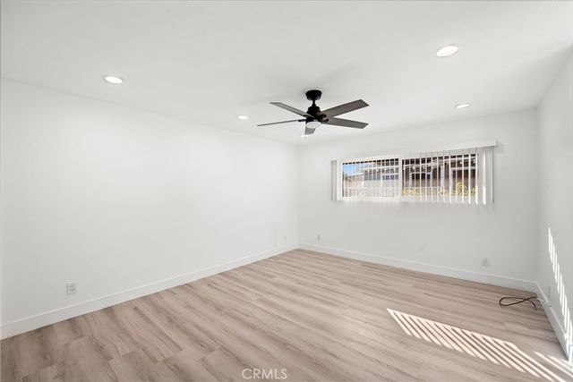 a view of a big room with wooden floor closet and windows