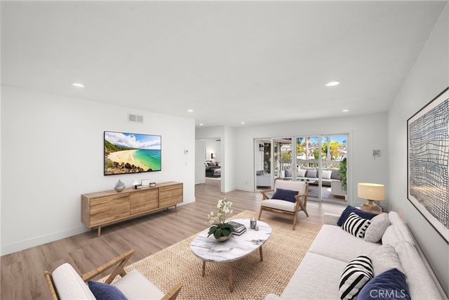 a living room with furniture a rug and a flat screen tv