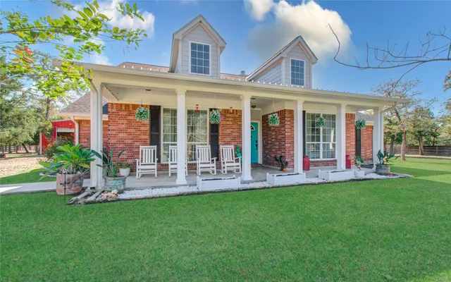 a view of a house with a yard porch and sitting area