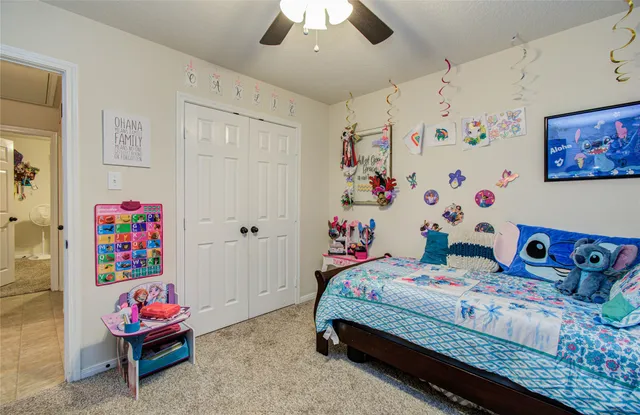 a bedroom that has a bed and a dresser in it