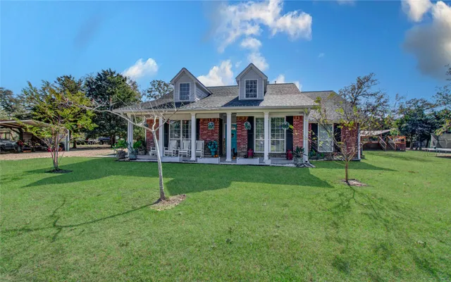 a view of a house with a yard and plants