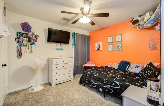 a bedroom with furniture and a flat tv screen