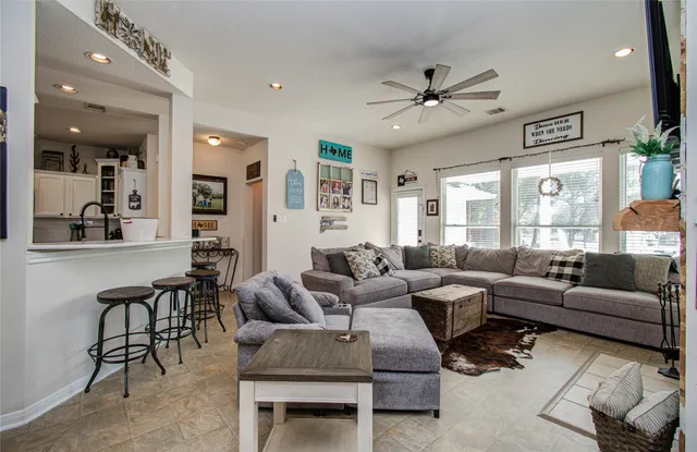 a living room with furniture and a large window