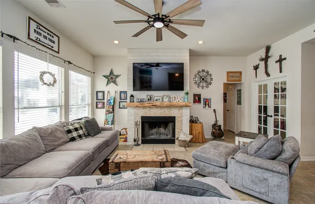 a living room with furniture a fireplace and a flat screen tv