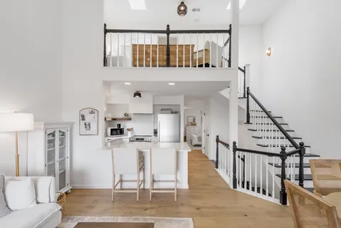 a living room with lots of furniture and a wooden floor