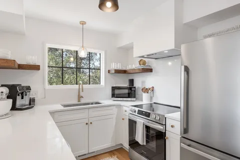 a kitchen with a sink stove and refrigerator