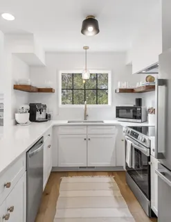 a kitchen with a sink stove and cabinets
