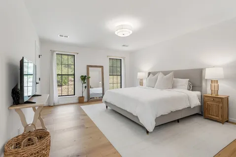 a spacious bedroom with a large bed and a window