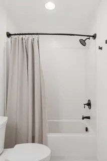 a bathroom with a shower and a toilet