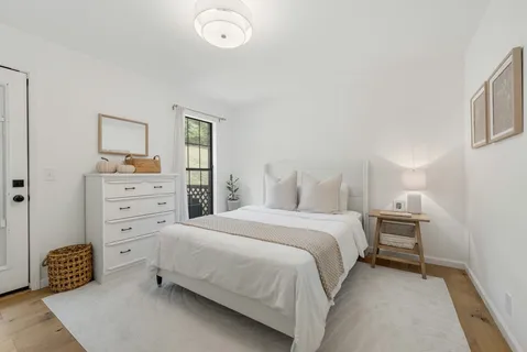 a bedroom with a bed and a window