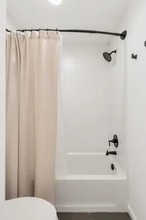 a bathroom with a shower and a toilet