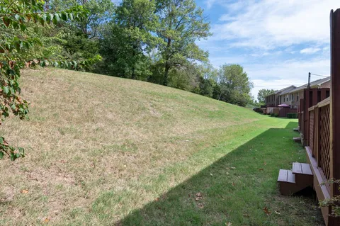 a front view of a house with a garden and garage