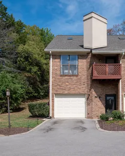 a view of a roof deck with wooden fence and a bench