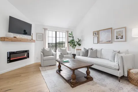 a living room with furniture flat screen tv and a fireplace