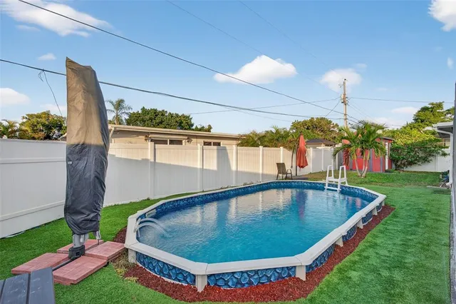 a front view of a house with a yard and outdoor seating