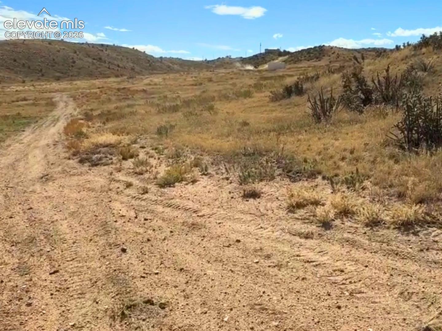 6650 Quail Road Fountain, CO 80817 - Photo 49 of 55 Expansive landscape with a dirt road, undulating terrain, and sparse natural vegetation