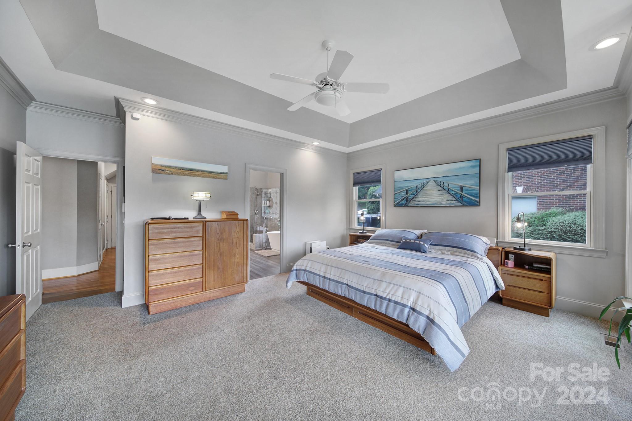 216 Edgewater Way Fort Mill, SC 29708 - Photo 19 of 45 a spacious bedroom with a large bed and a chandelier