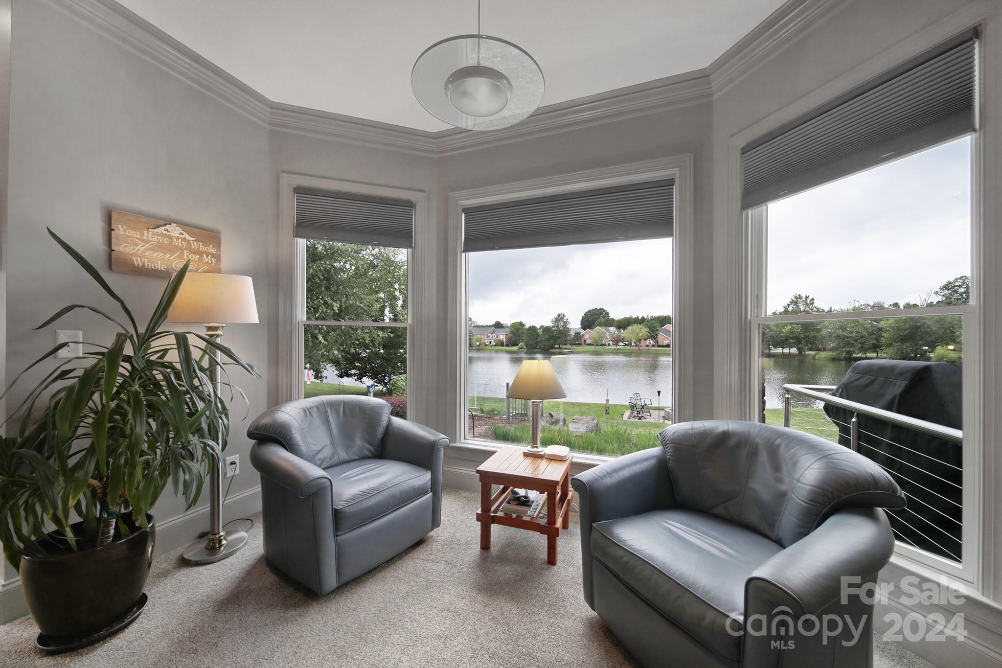 216 Edgewater Way Fort Mill, SC 29708 - Photo 21 of 45 a living room with furniture and a floor to ceiling window