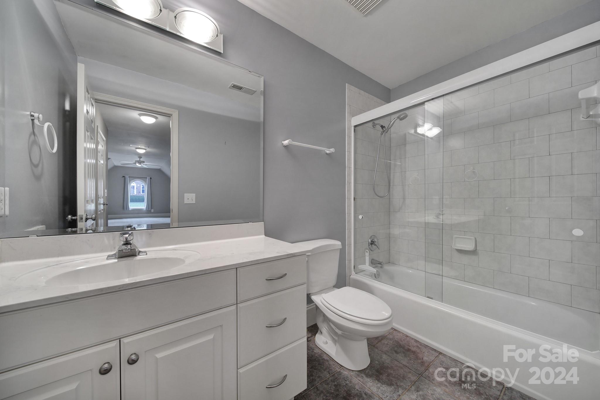 216 Edgewater Way Fort Mill, SC 29708 - Photo 31 of 45 a bathroom with a sink a toilet a mirror and bathtub