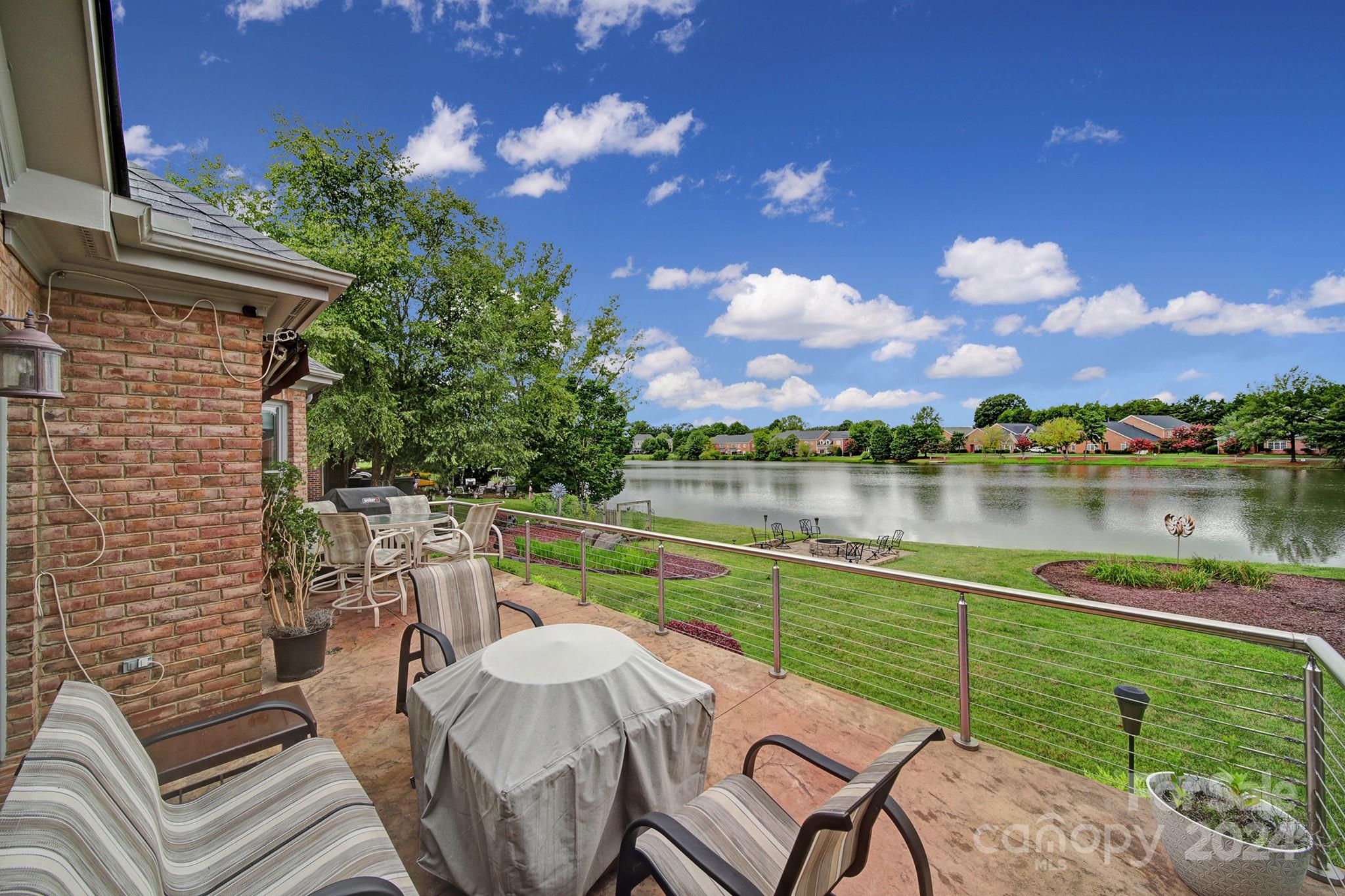 216 Edgewater Way Fort Mill, SC 29708 - Photo 41 of 45 a view of a lake with couches chairs
