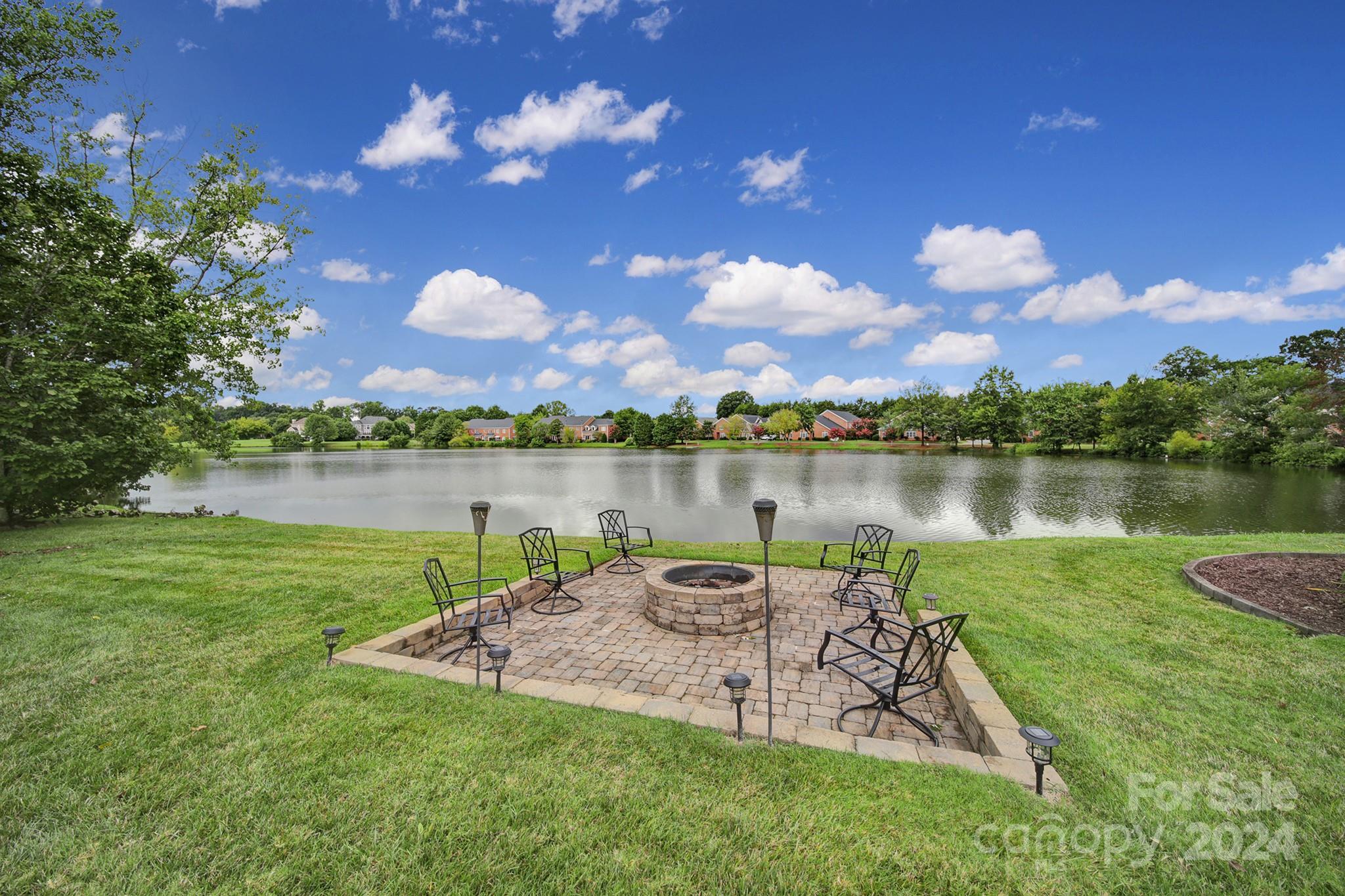 216 Edgewater Way Fort Mill, SC 29708 - Photo 5 of 45 a view of a lake with houses in the back