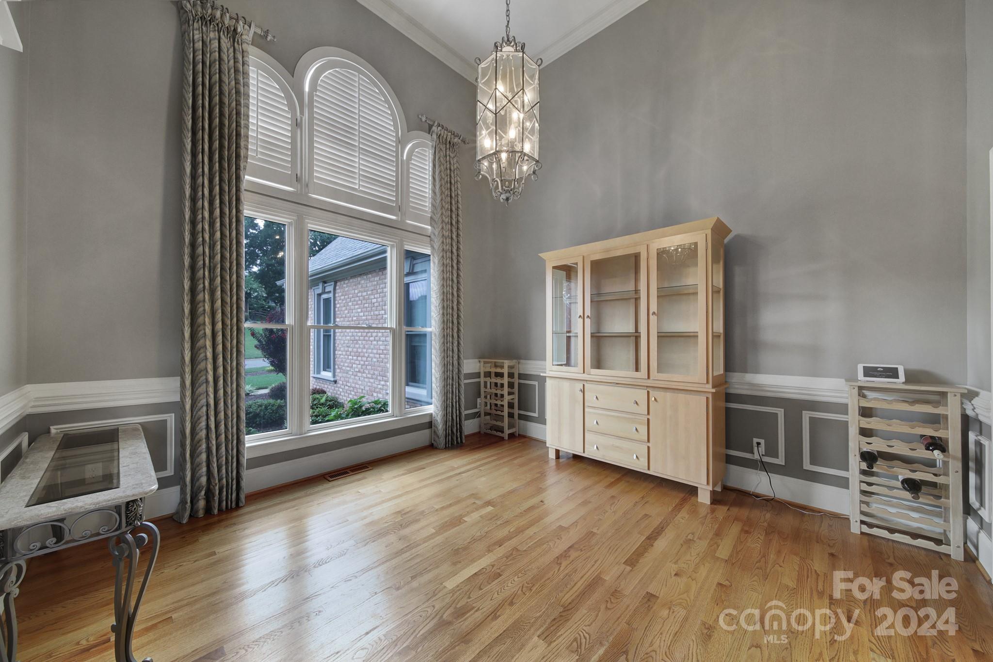 216 Edgewater Way Fort Mill, SC 29708 - Photo 7 of 45 a view of a livingroom with furniture wooden floor chandelier and windows
