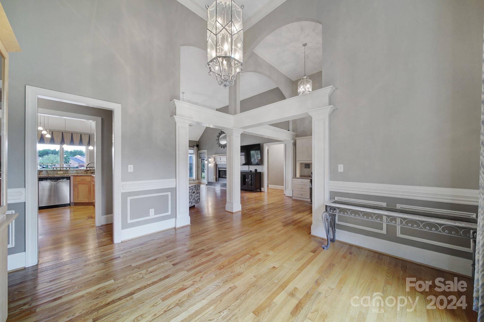 216 Edgewater Way Fort Mill, SC 29708 - Photo 8 of 45 a view of a livingroom with wooden floor and a kitchen space