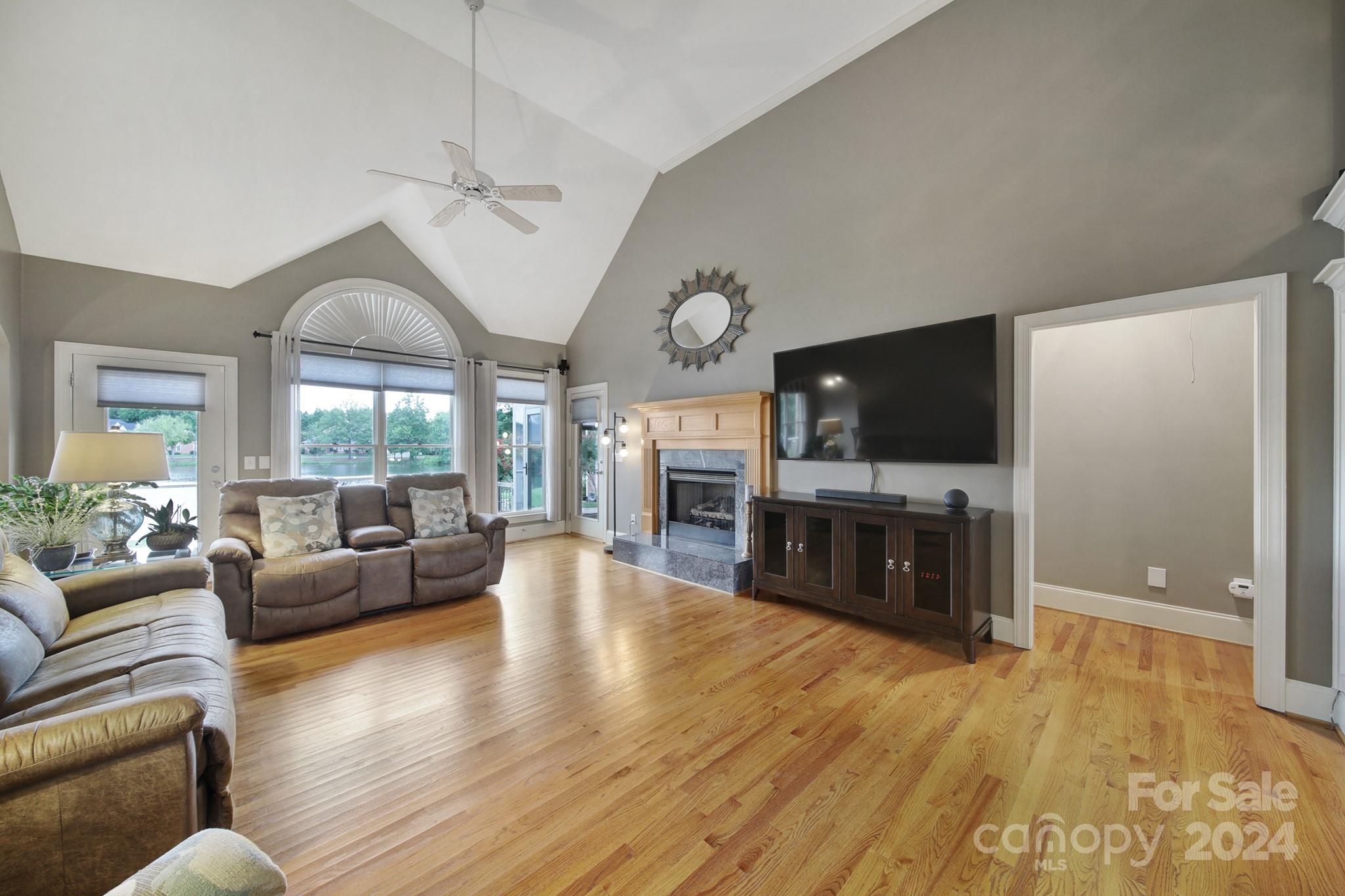 216 Edgewater Way Fort Mill, SC 29708 - Photo 9 of 45 a living room with furniture a flat screen tv and a fireplace