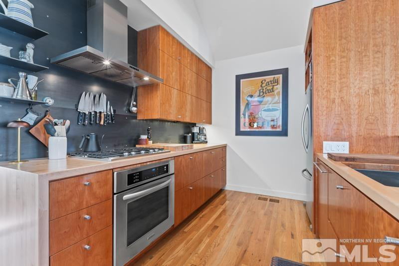 643 John Fremont Drive Reno, NV 89509 - Photo 18 of 42 a kitchen with stainless steel appliances granite countertop a stove and a sink