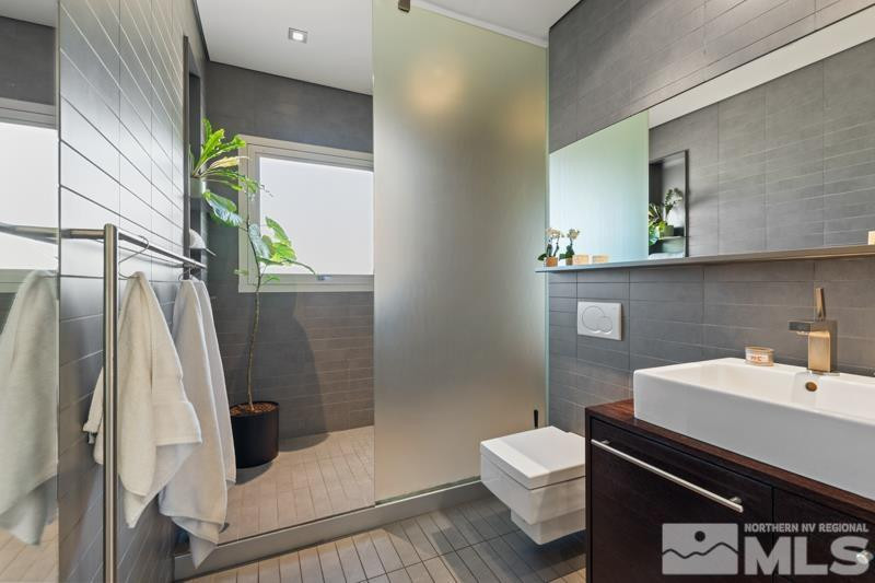 643 John Fremont Drive Reno, NV 89509 - Photo 26 of 42 a bathroom with a sink and a mirror
