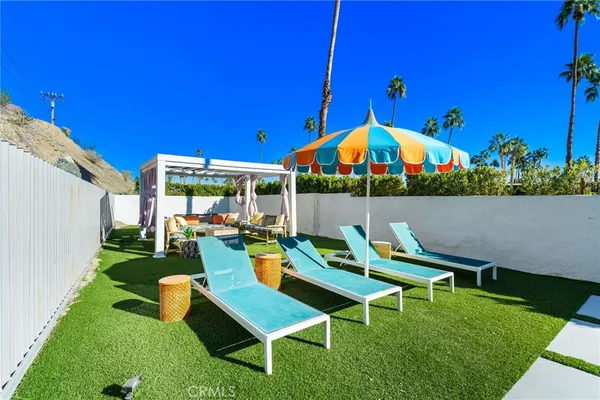 a view of an outdoor sitting area with furniture and umbrella