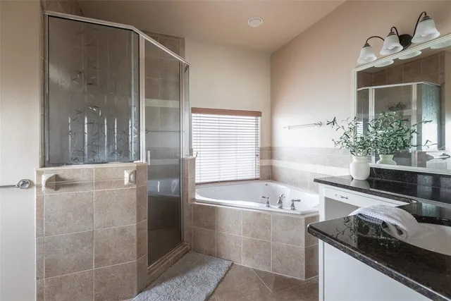 a view of walk in closet with clothes