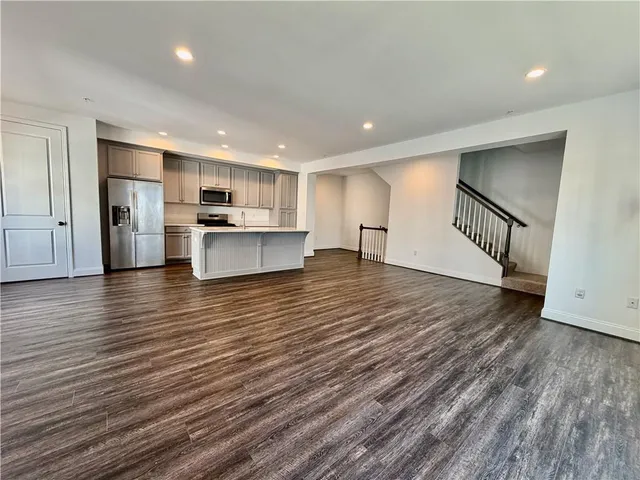 a view of kitchen with sink microwave and refrigerator