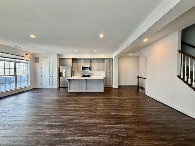 a view of kitchen and hall with wooden floor