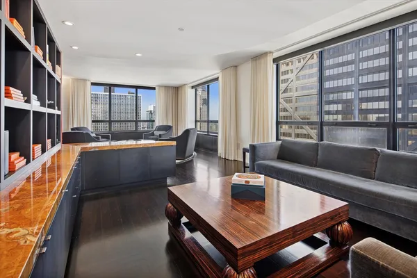 a dining room with furniture window and wooden floor