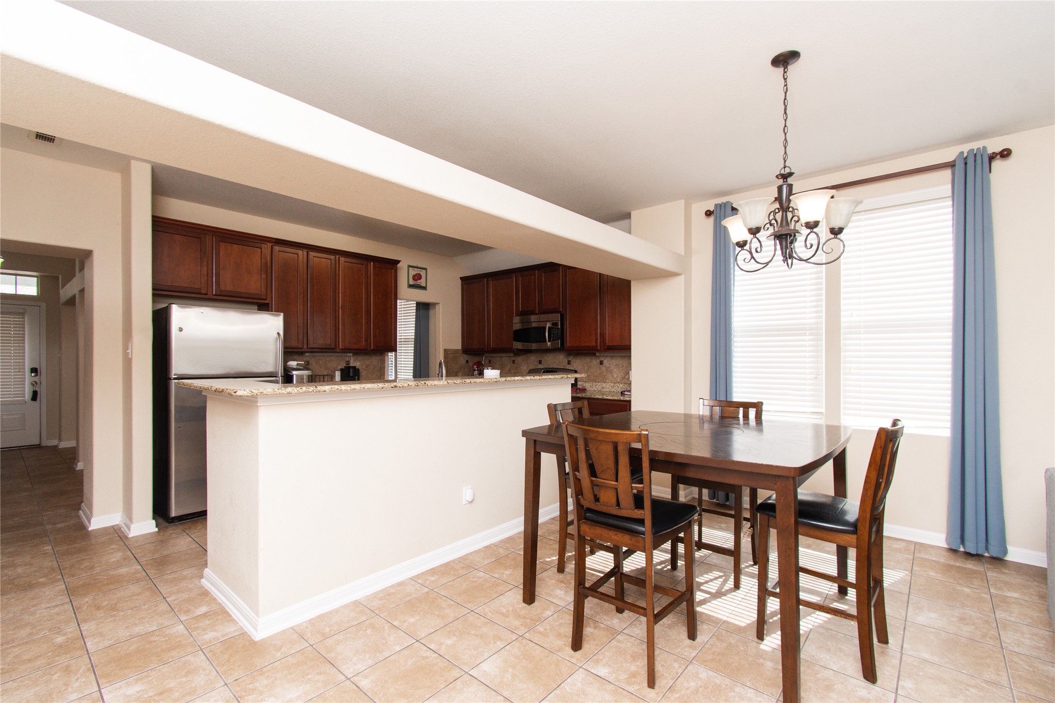 421 Shadow Point San Marcos, TX 78666 - Photo 8 of 24 Dining space featuring hanging lights and light tile patterned flooring
