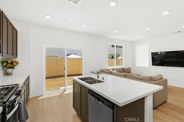 a kitchen with a stove a sink and a refrigerator