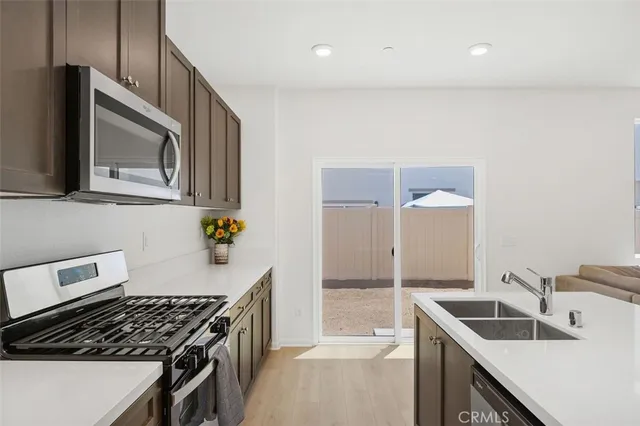 a kitchen that has a sink and a stove