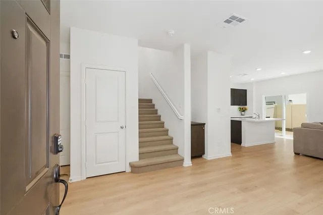 a view of a kitchen with furniture and wooden floor