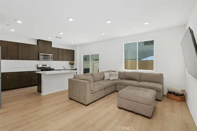 a living room with furniture and kitchen view